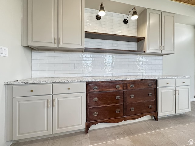 120 S 200 E, Castle Dale, UT 84513 - kitchen featuring tasteful backsplash, dark brown cabinetry, light stone counters, and open shelves