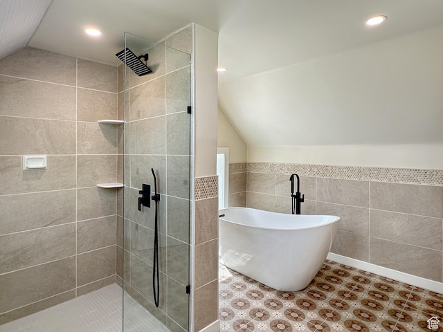 120 S 200 E, Castle Dale, UT 84513 - bathroom featuring a freestanding bath, lofted ceiling, recessed lighting, tiled shower, and tile walls