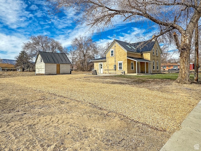 120 S 200 E, Castle Dale, UT 84513 - view of side of property featuring an outbuilding and brick siding