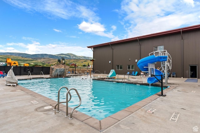140 W 150th St S Unit D12, Garden City, UT 84028 - pool featuring a mountain view, a patio, a water slide, and fence