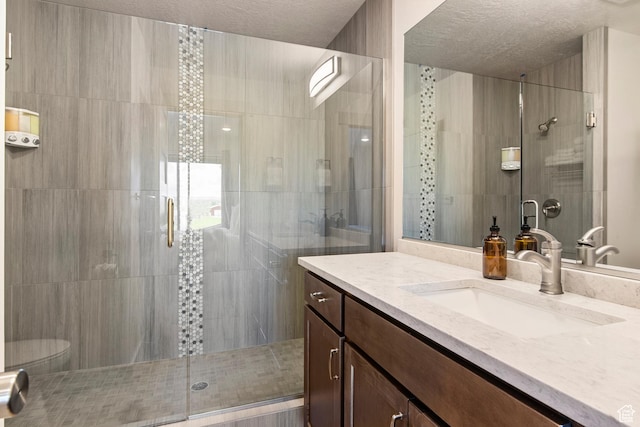 140 W 150th St S Unit D12, Garden City, UT 84028 - full bath with a textured ceiling, a stall shower, vanity, and toilet