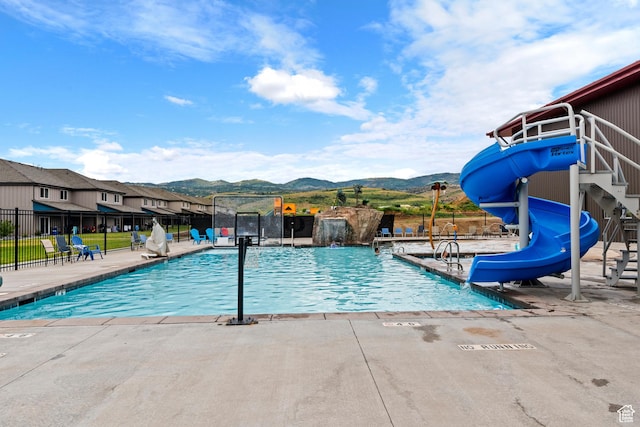 140 W 150th St S Unit D12, Garden City, UT 84028 - pool with a patio, fence, playground community, a water slide, and a mountain view