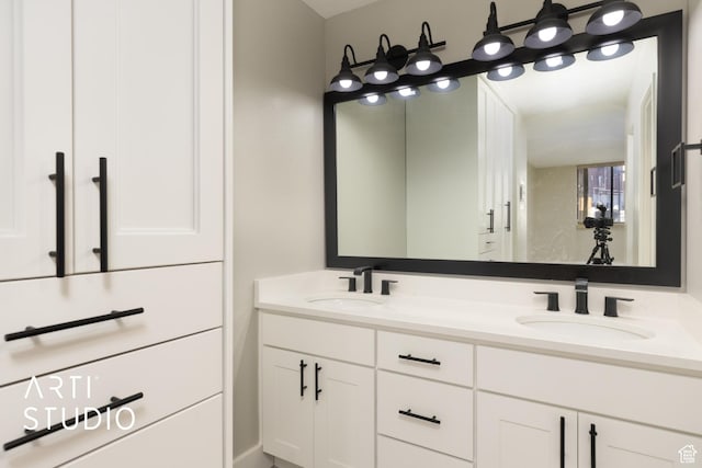 full bathroom with double vanity and a sink