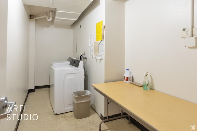 clothes washing area featuring separate washer and dryer and laundry area