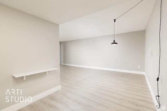 empty room with light wood-type flooring and baseboards