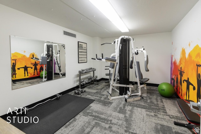 workout area featuring visible vents, carpet flooring, and baseboards