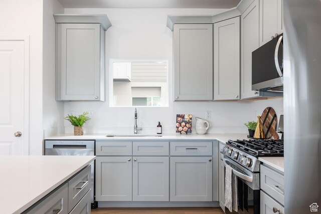 4463 S 500 E Unit 49, Millcreek, UT 84107 - kitchen featuring freestanding refrigerator, gray cabinets, light countertops, and gas range