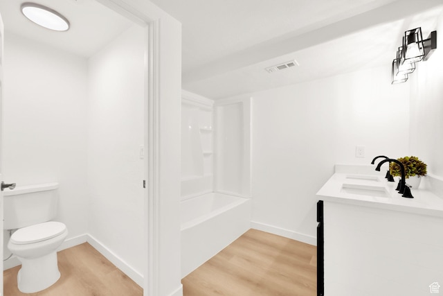 7898 N Tinamous Rd, Eagle Mountain, UT 84005 - full bathroom with visible vents, toilet, wood finished floors, and a sink