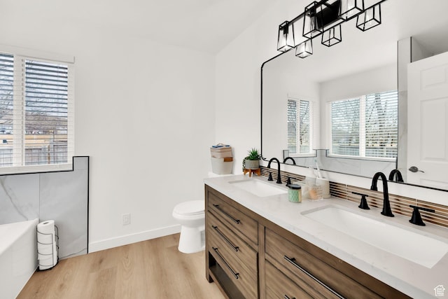 7898 N Tinamous Rd, Eagle Mountain, UT 84005 - full bath featuring double vanity, toilet, wood finished floors, and a sink