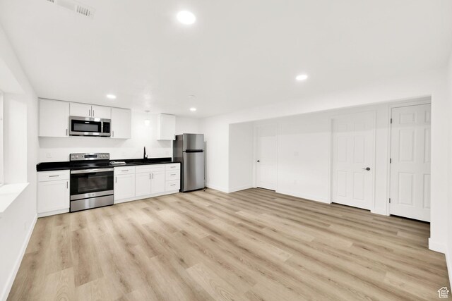 7898 N Tinamous Rd, Eagle Mountain, UT 84005 - kitchen featuring recessed lighting, light wood-type flooring, appliances with stainless steel finishes, and white cabinetry