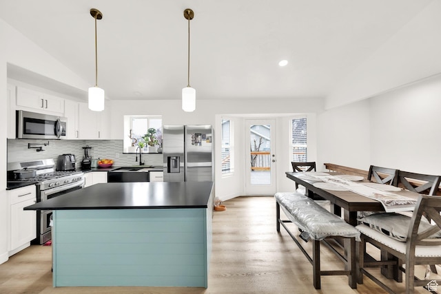 7898 N Tinamous Rd, Eagle Mountain, UT 84005 - kitchen with a sink, tasteful backsplash, dark countertops, stainless steel appliances, and vaulted ceiling