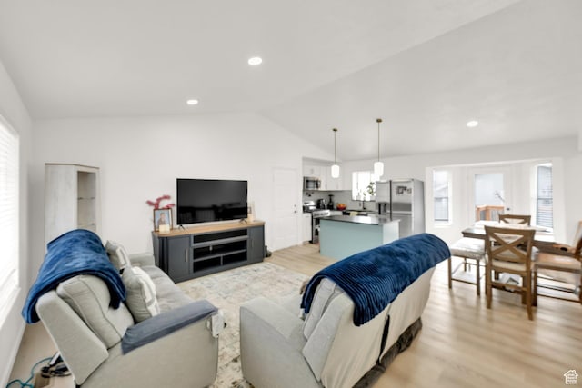 7898 N Tinamous Rd, Eagle Mountain, UT 84005 - living room featuring vaulted ceiling, recessed lighting, and light wood-style floors