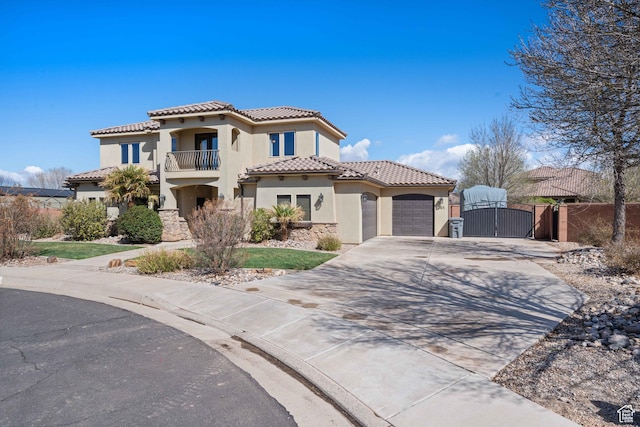 265 E Kimball Ct, Washington, UT 84780 - mediterranean / spanish-style house featuring concrete driveway, a tile roof, stucco siding, a balcony, and a gate