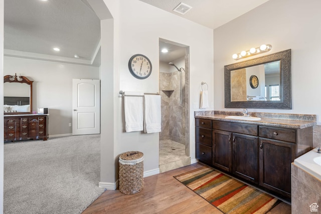 265 E Kimball Ct, Washington, UT 84780 - bathroom featuring visible vents, wood finished floors, vanity, and a walk in shower