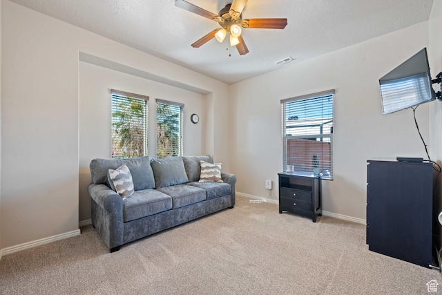 265 E Kimball Ct, Washington, UT 84780 - living room with visible vents, baseboards, carpet, ceiling fan, and a textured ceiling