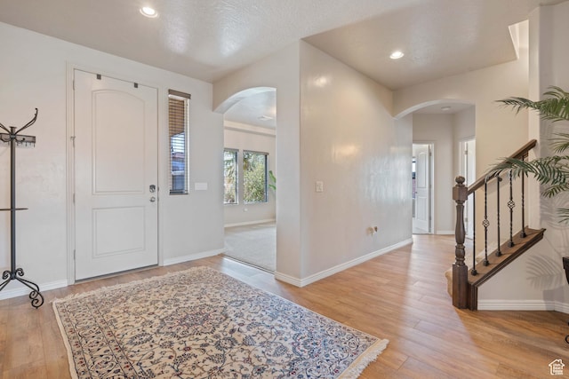265 E Kimball Ct, Washington, UT 84780 - foyer featuring baseboards, stairway, light wood-type flooring, recessed lighting, and arched walkways