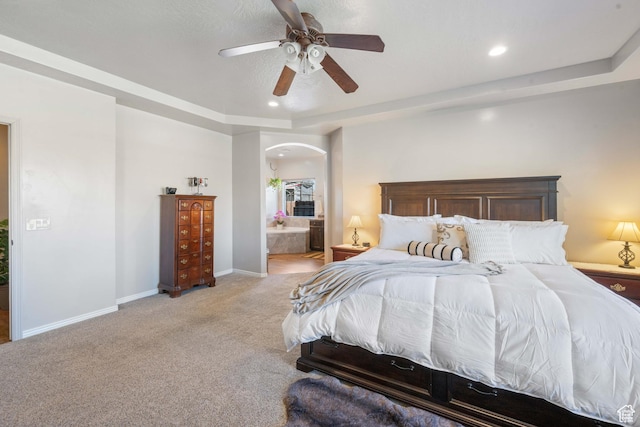 265 E Kimball Ct, Washington, UT 84780 - bedroom featuring light carpet, ensuite bathroom, a tray ceiling, arched walkways, and baseboards