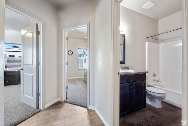 265 E Kimball Ct, Washington, UT 84780 - full bathroom featuring vanity, wood finished floors, baseboards, bathtub / shower combination, and toilet