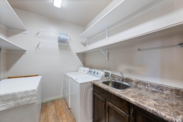 265 E Kimball Ct, Washington, UT 84780 - washroom featuring a sink, cabinet space, light wood-style floors, and washing machine and clothes dryer