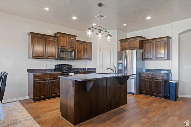 265 E Kimball Ct, Washington, UT 84780 - kitchen featuring a sink, stainless steel appliances, dark brown cabinetry, and wood finished floors