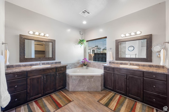 265 E Kimball Ct, Washington, UT 84780 - bathroom with a bath, visible vents, two vanities, and a sink