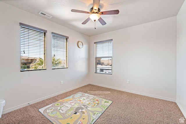265 E Kimball Ct, Washington, UT 84780 - spare room featuring visible vents, baseboards, light colored carpet, and a ceiling fan