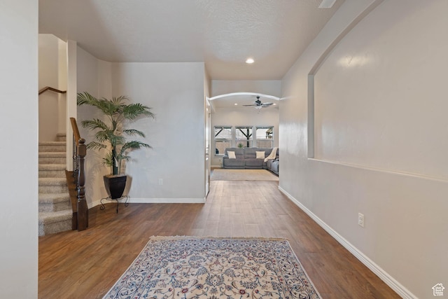 265 E Kimball Ct, Washington, UT 84780 - hall featuring baseboards, arched walkways, wood finished floors, and stairway