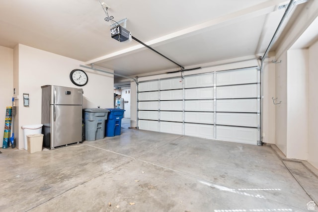 265 E Kimball Ct, Washington, UT 84780 - garage featuring a garage door opener and freestanding refrigerator