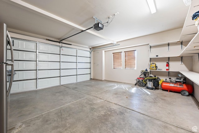 265 E Kimball Ct, Washington, UT 84780 - garage featuring freestanding refrigerator and a garage door opener