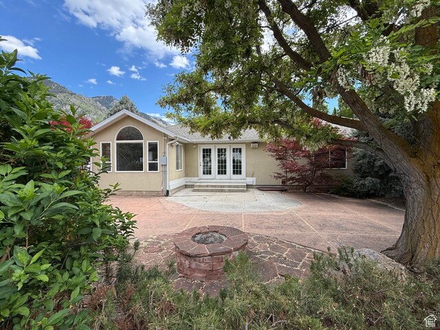 1164 E 2650 N, North Ogden, UT 84414 - rear view of house with french doors, stucco siding, a patio area, and a fire pit