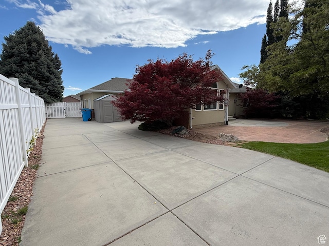 1164 E 2650 N, North Ogden, UT 84414 - view of home's exterior featuring a patio area, driveway, and a shed