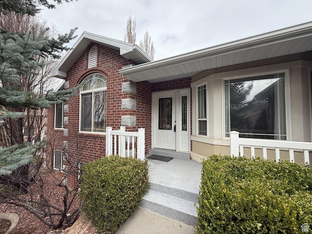 property entrance featuring brick siding