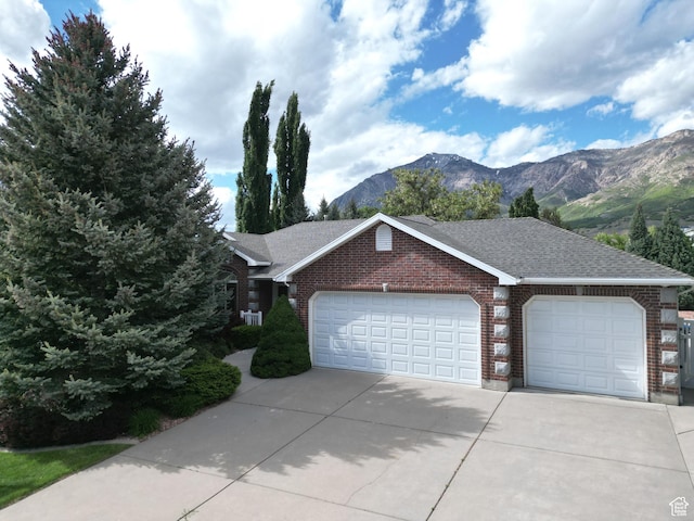 1164 E 2650 N, North Ogden, UT 84414 - view of front of house featuring brick siding, an attached garage, driveway, and a mountain view