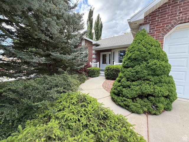 1164 E 2650 N, North Ogden, UT 84414 - view of property exterior with brick siding, a garage, and roof with shingles