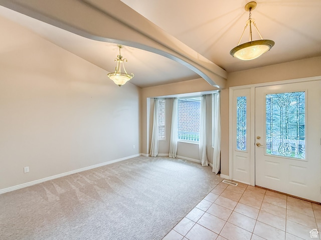 foyer entrance featuring visible vents, baseboards, lofted ceiling with beams, light carpet, and light tile patterned floors