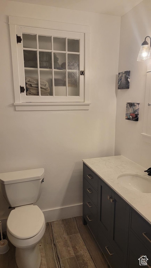 596 W 200 S, Vernal, UT 84078 - bathroom with baseboards, toilet, wood finished floors, and vanity