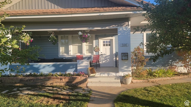 view of exterior entry with covered porch