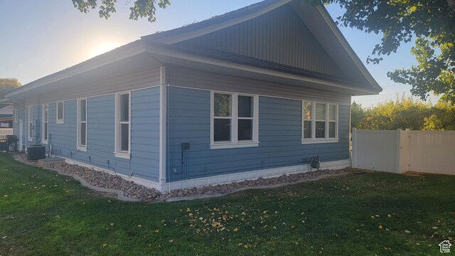 596 W 200 S, Vernal, UT 84078 - view of side of home with central AC unit, a yard, and fence