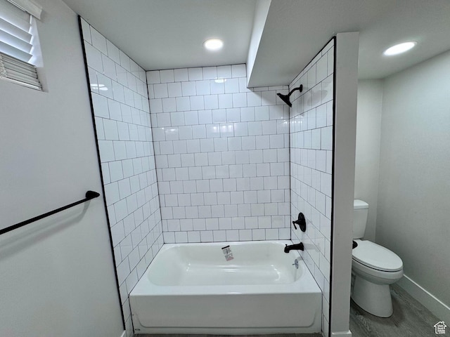 full bathroom featuring toilet, wood finished floors, baseboards, tub / shower combination, and recessed lighting