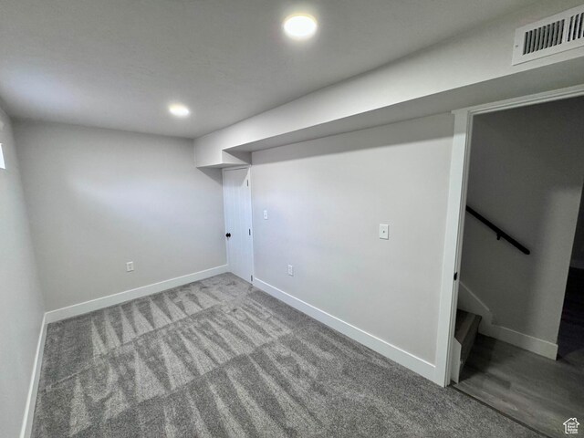 finished below grade area with baseboards, carpet floors, and visible vents