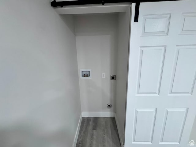 clothes washing area featuring baseboards, washer hookup, wood finished floors, laundry area, and hookup for an electric dryer