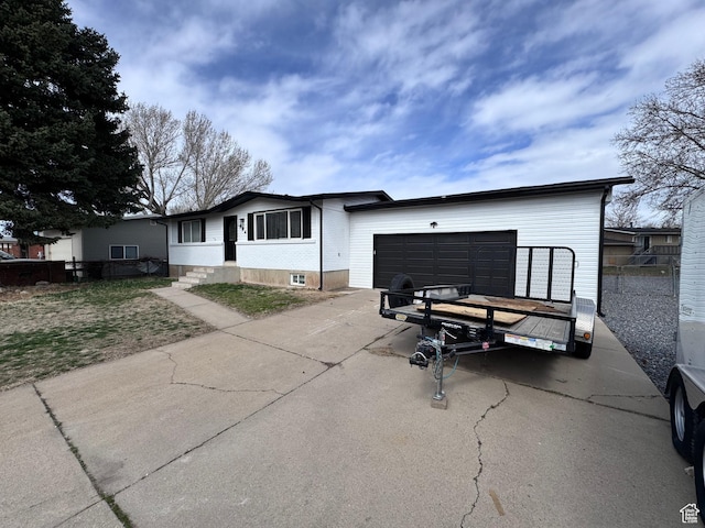 single story home with driveway and an attached garage