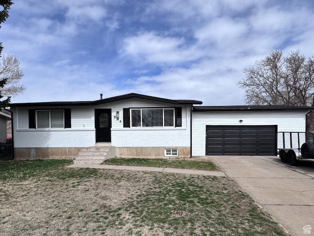 view of front of property featuring an attached garage, brick siding, and concrete driveway
