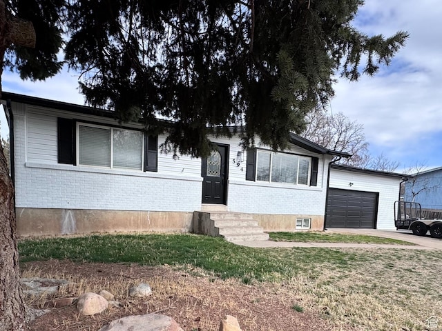 single story home with brick siding, driveway, and an attached garage