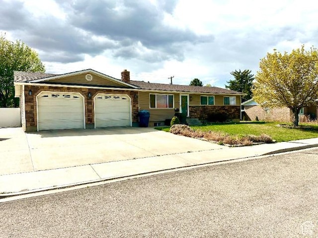 384 S 350 W, Vernal, UT 84078 - ranch-style house with a garage, driveway, a front lawn, and a chimney