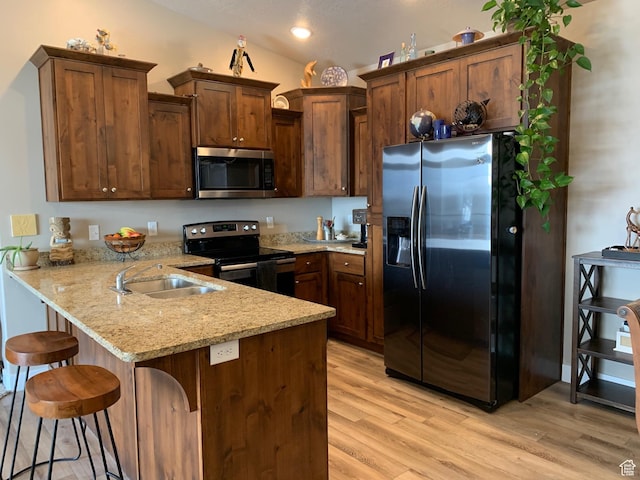 1128 S 820 E Unit 7304, Heber City, UT 84032 - kitchen featuring light stone counters, a peninsula, a sink, stainless steel appliances, and light wood-style floors