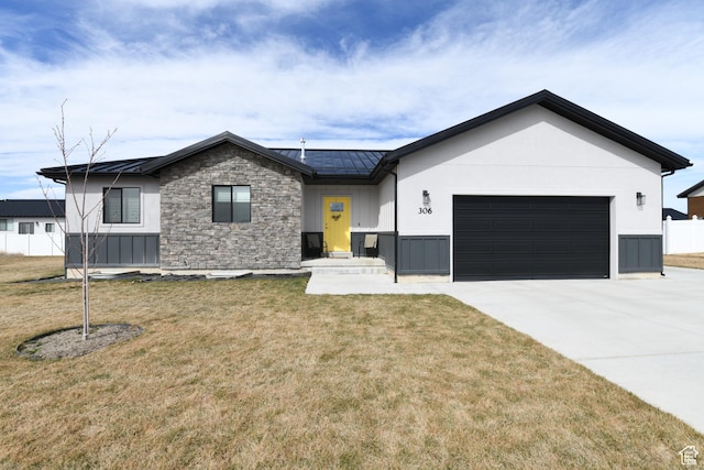 306 W 450 S, Ephraim, UT 84627 - view of front of property with an attached garage, concrete driveway, a standing seam roof, stone siding, and a metal roof