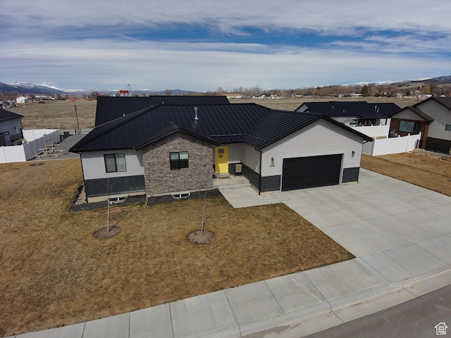 306 W 450 S, Ephraim, UT 84627 - modern farmhouse with a standing seam roof, a garage, concrete driveway, a metal roof, and a mountain view