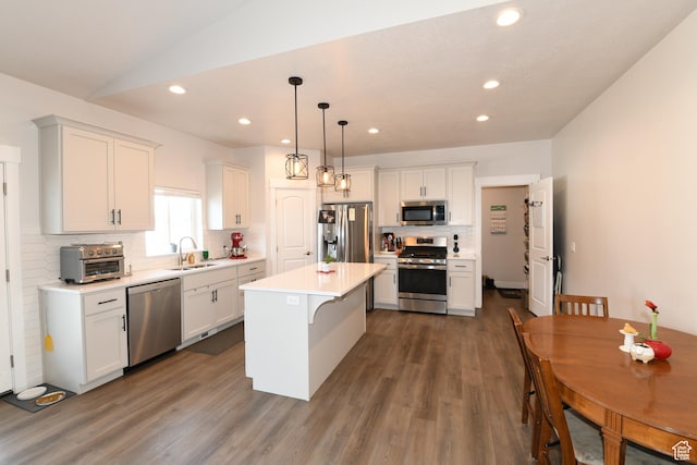 306 W 450 S, Ephraim, UT 84627 - kitchen featuring appliances with stainless steel finishes, decorative backsplash, dark wood-type flooring, recessed lighting, and white cabinetry