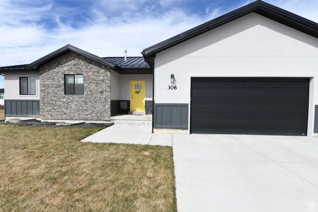 306 W 450 S, Ephraim, UT 84627 - view of front of property featuring a standing seam roof, stone siding, driveway, a garage, and a metal roof